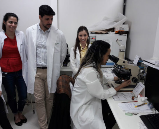 Os Estagiários de DST de novembro de 2017 e as Colaboradoras do CEADS , a Dra. Nathalia Targa Pinto e a Biomédica Fátima Morais, durante a exposição de lâminas com os agentes etiológicos de DST.